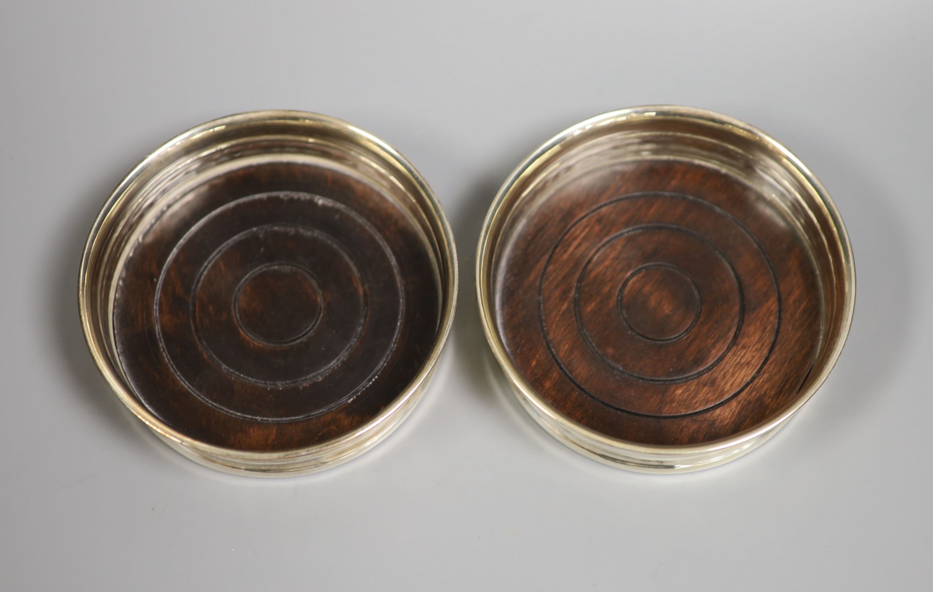 A pair of Italian 925 bottle coasters, with turned wooden bases, 11.4cm.